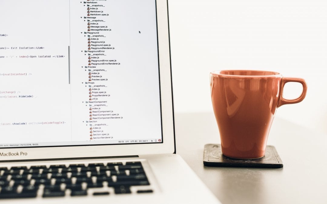 Reasons to Test Software represented by computer and coffee mug