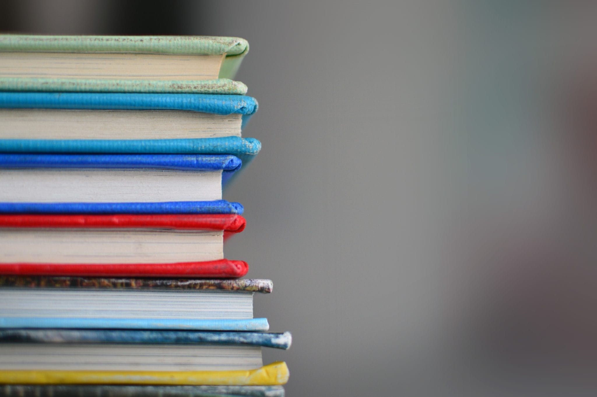 QA education represented by a stack of books