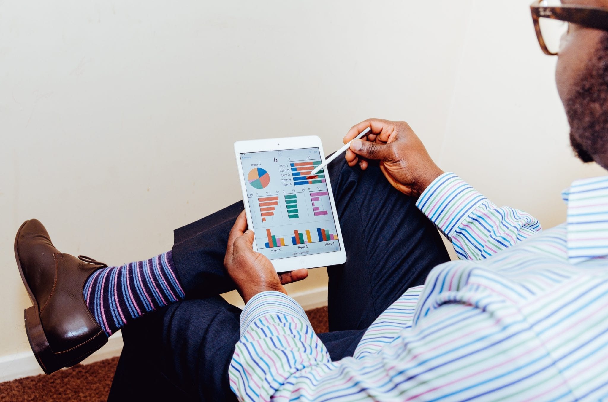 outsourced software testing represented by man holding a tablet