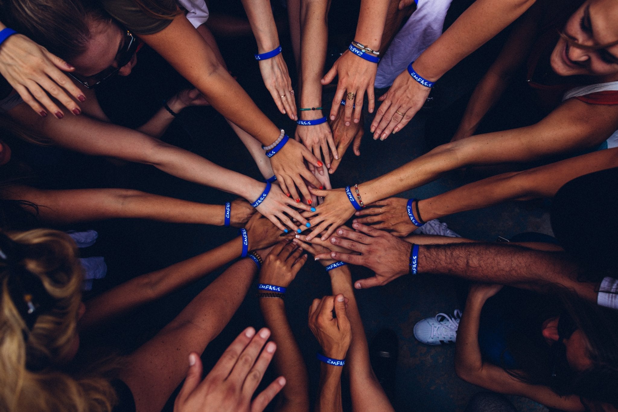 "outsourced qa" represented by a group of hands in a circle