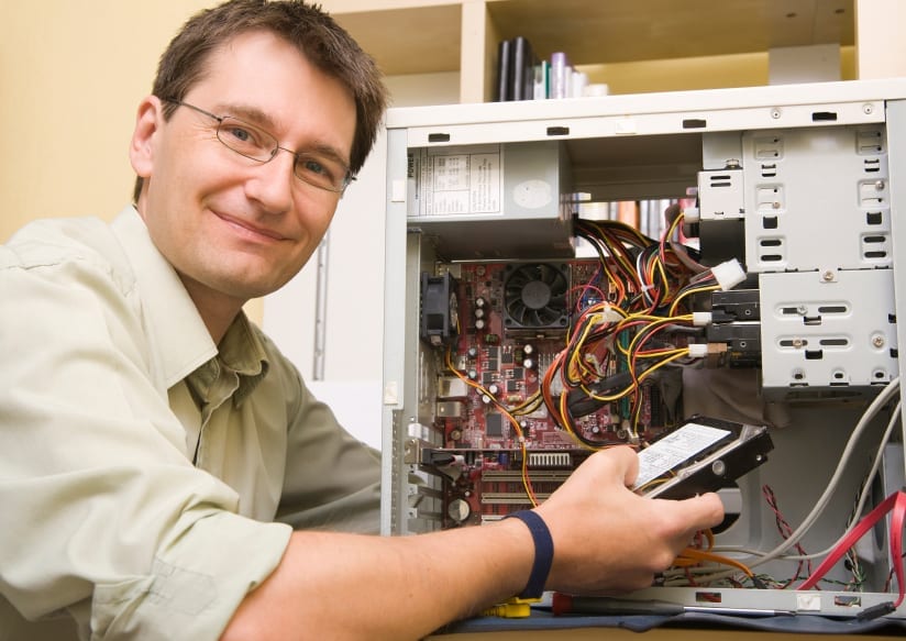 quality assurance represented by man hard-wiring a computer