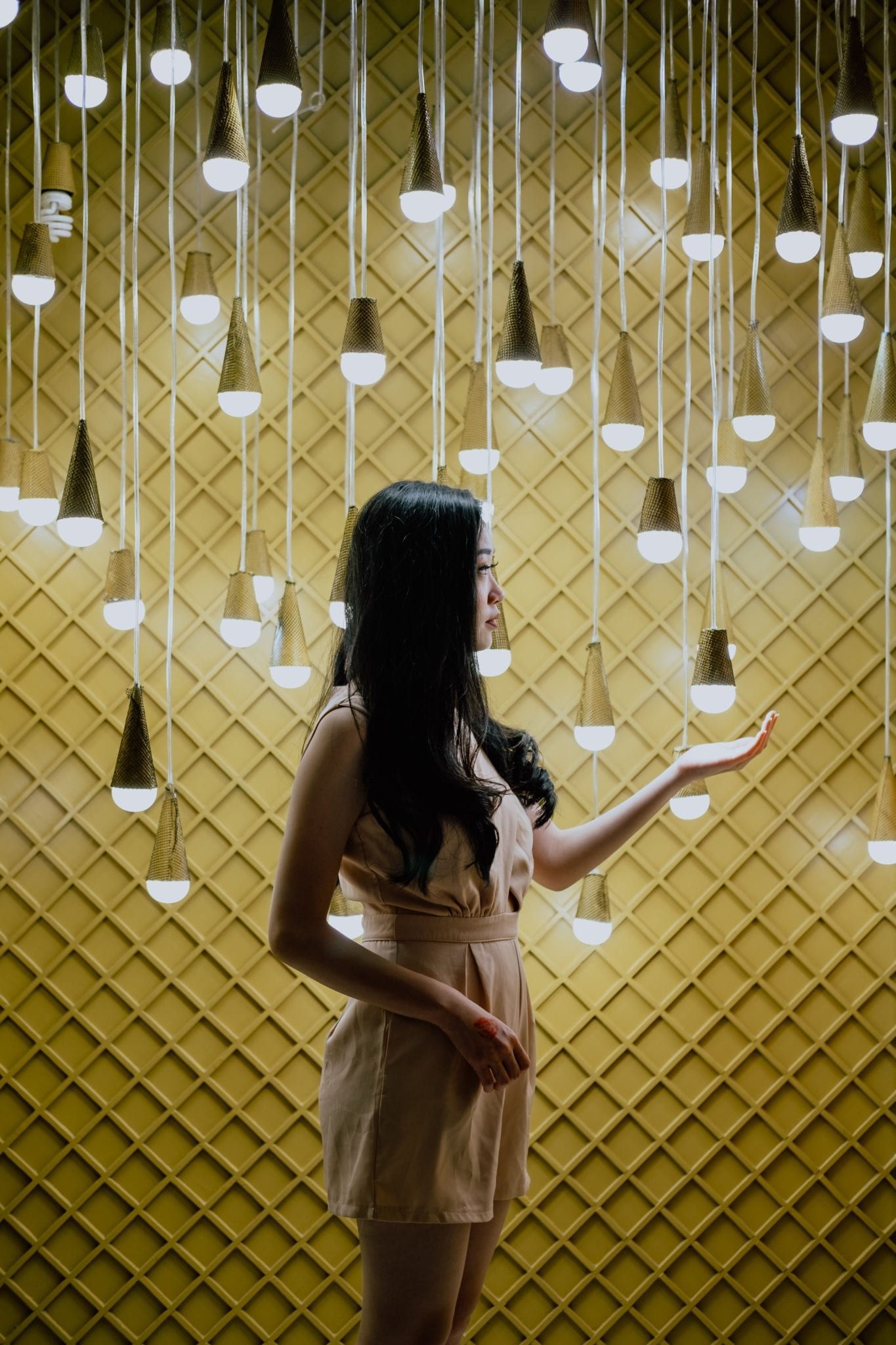 different software tests represented by woman surrounded by hanging light bulbs