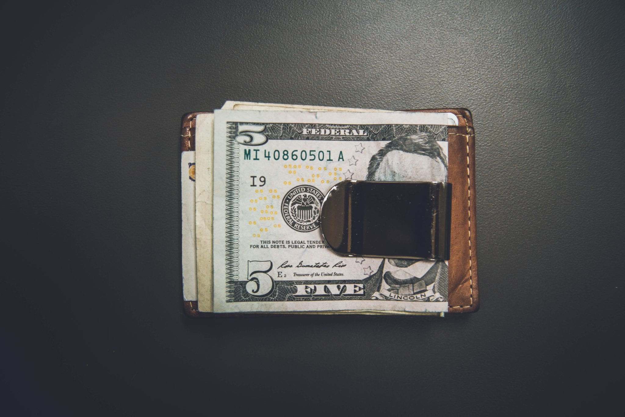 the cost of software testing represented by a money clip